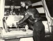 Firefighters With Patient in Ambulance